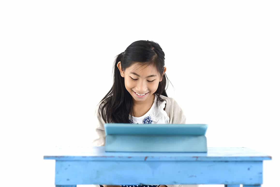 Girl at blue desk studying and learning about careers