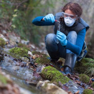 Conservation Scientist takes soil sample