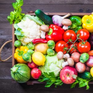 Agriculture, Food & Natural Resources Career Cluster image of basket filled with colorful fresh vegetables on a picnic table