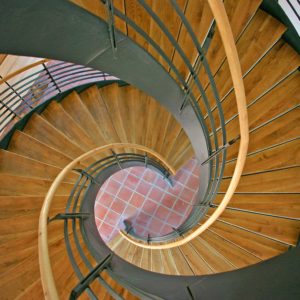 Architecture & Construction Career Cluster image of looking down a beautifully design wood and metal spiral staircase