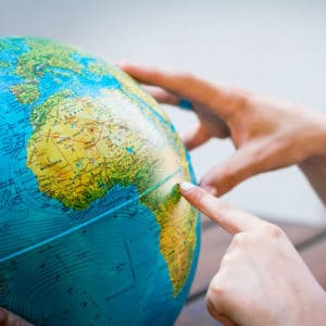 Geographer studies a world globe