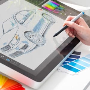 Industrial Designer Career - woman holding a stylus creating a design on an interactive screen pad