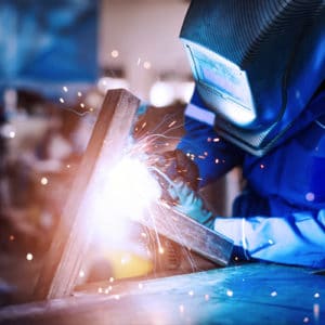 Mechanical Engineer welding iron beams to build a structure support