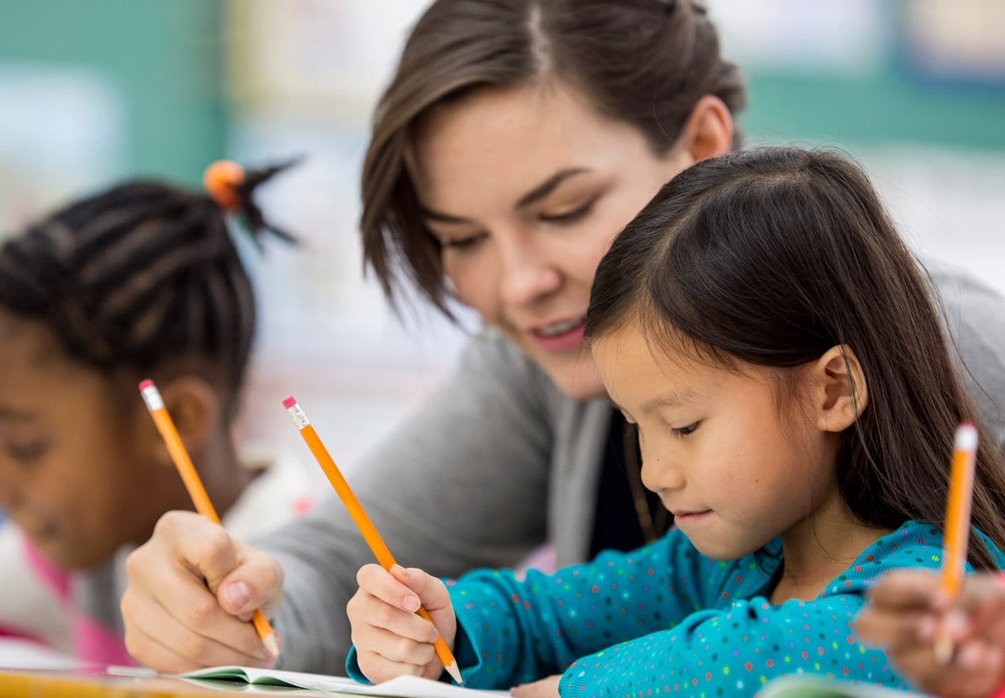 Teacher assisting student in class