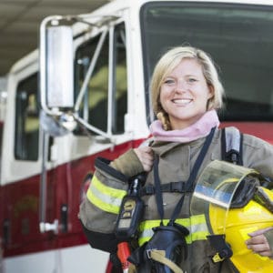 Fire Fighter standing in front of fire truck