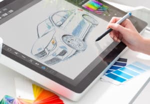Woman sketches an automobile design with a stylus on a computer tablet