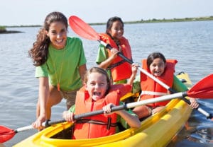 Recreation manager in kayak with children