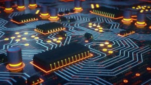 Computer scientist designed circuit board showing electronic glow in yellow against a dark blue background
