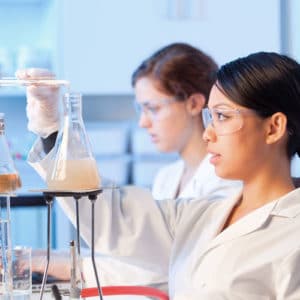 Biochemist & Biophysicist perform laboratory experiment in coats