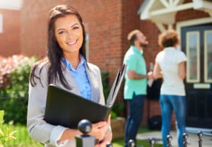 Real estate agent showing a couple a house