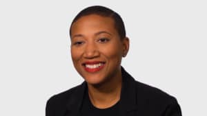 Career Girls architect role model Kimberly Dowdell profile image wearing black jacket against a neutral gray background