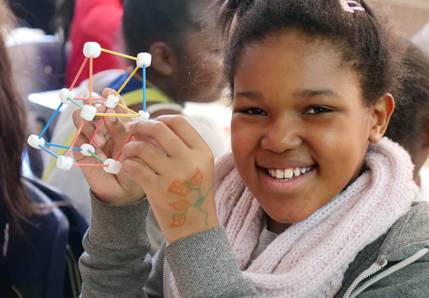 Girl with completed marshmallow group empowerment activity in her hand