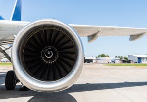 Aeronautics image of airplane engine and wing on airport tarmac