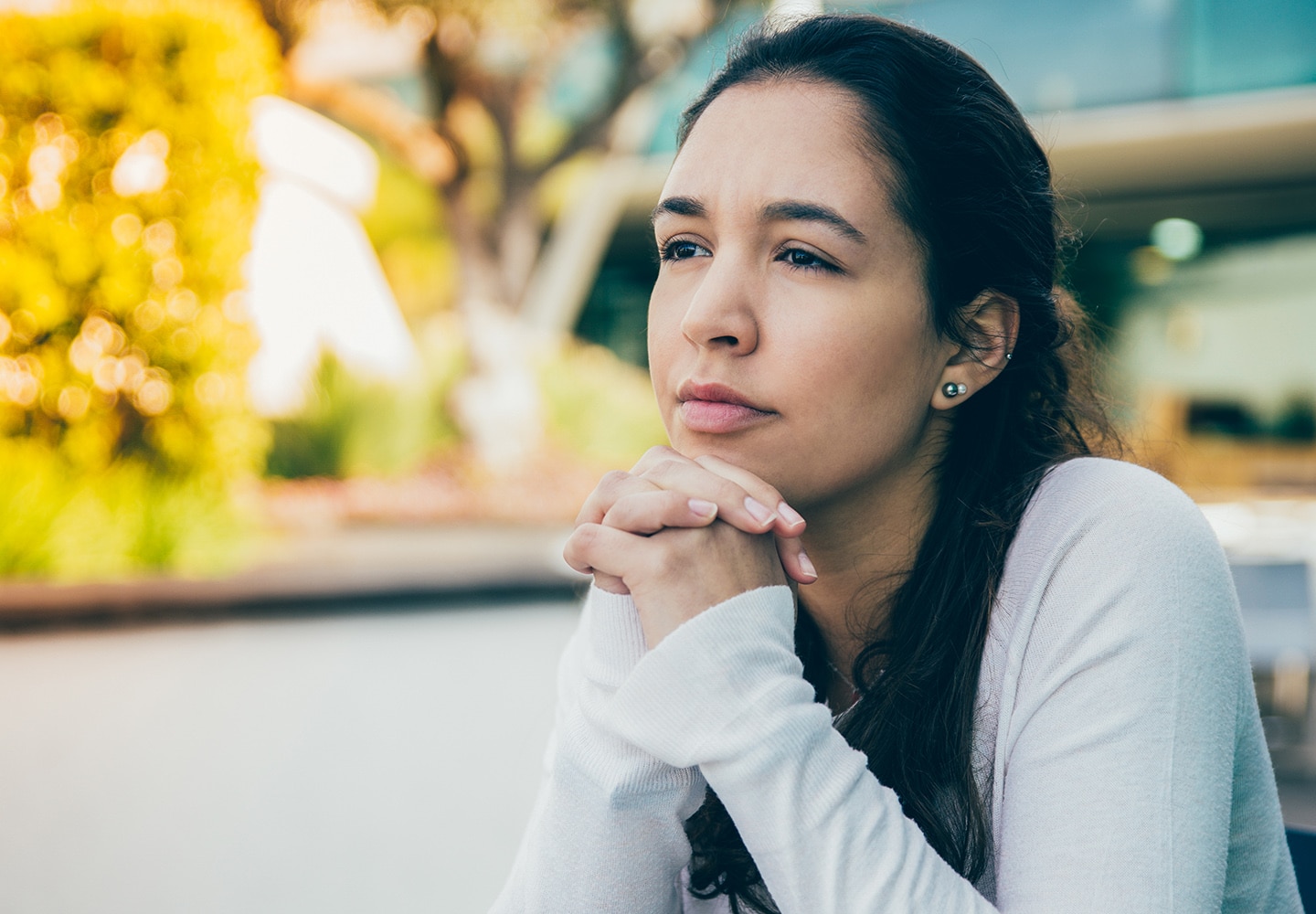 Philosophical gaze from a young woman at a table thinking about life
