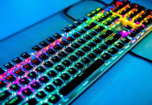 Video game designer keyboard with multiple colors glowing behind keys
