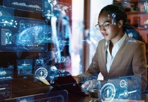 Young Black woman data scientist at work in front of computer