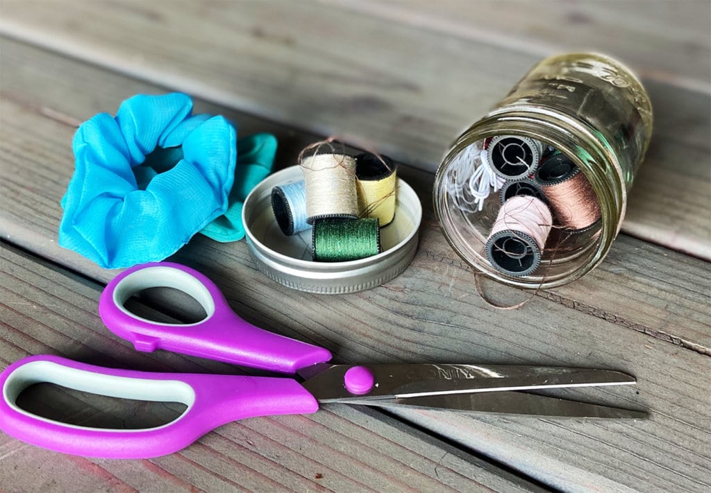 Bright blue cloth, thread and scissors - materials to make a scrunchie as a friendship group activity for girls