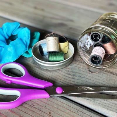 Bright blue cloth, thread and scissors - materials to make a scrunchie as a friendship group activity for girls