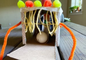 Exit final end ping pong ball going through cardboard tube at top of obstacle course activity