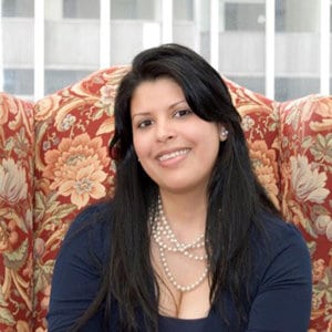 Johanna Castillo bio headshot at desk