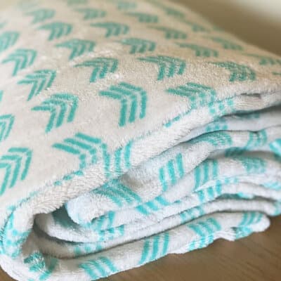 Flip The Blanket Empowerment Activity for Career Girls Problem Solving Empowerment Video. A green and white folded soft blanket.