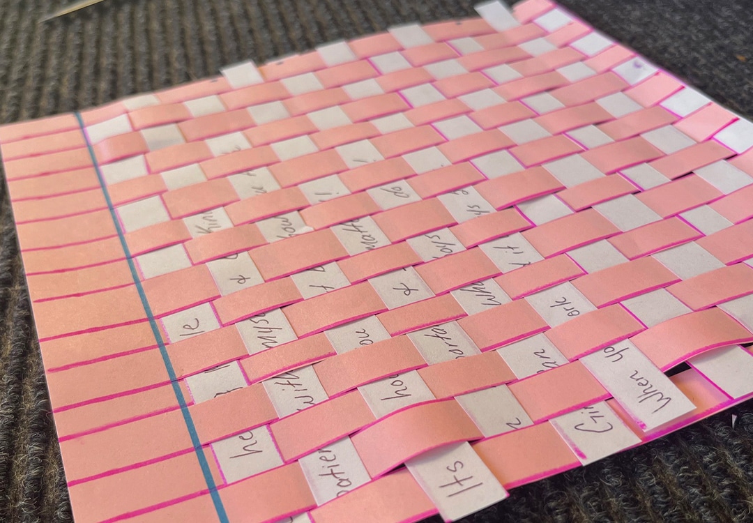 Weaving together life lessons Empowerment Activity image of colorful paper weaved together with writing.