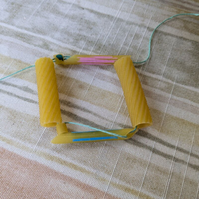 Genetics Empowerment Video Group Activity - Genetics DNA Model From Pasta - string the group and then string through both pasta pieces the other way